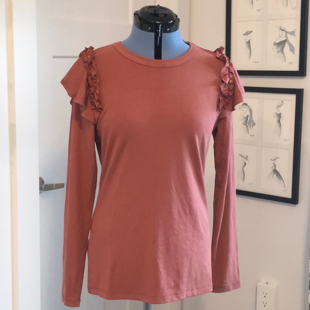 Cute rose-copper colored T shirt with ruffles on shoulders.